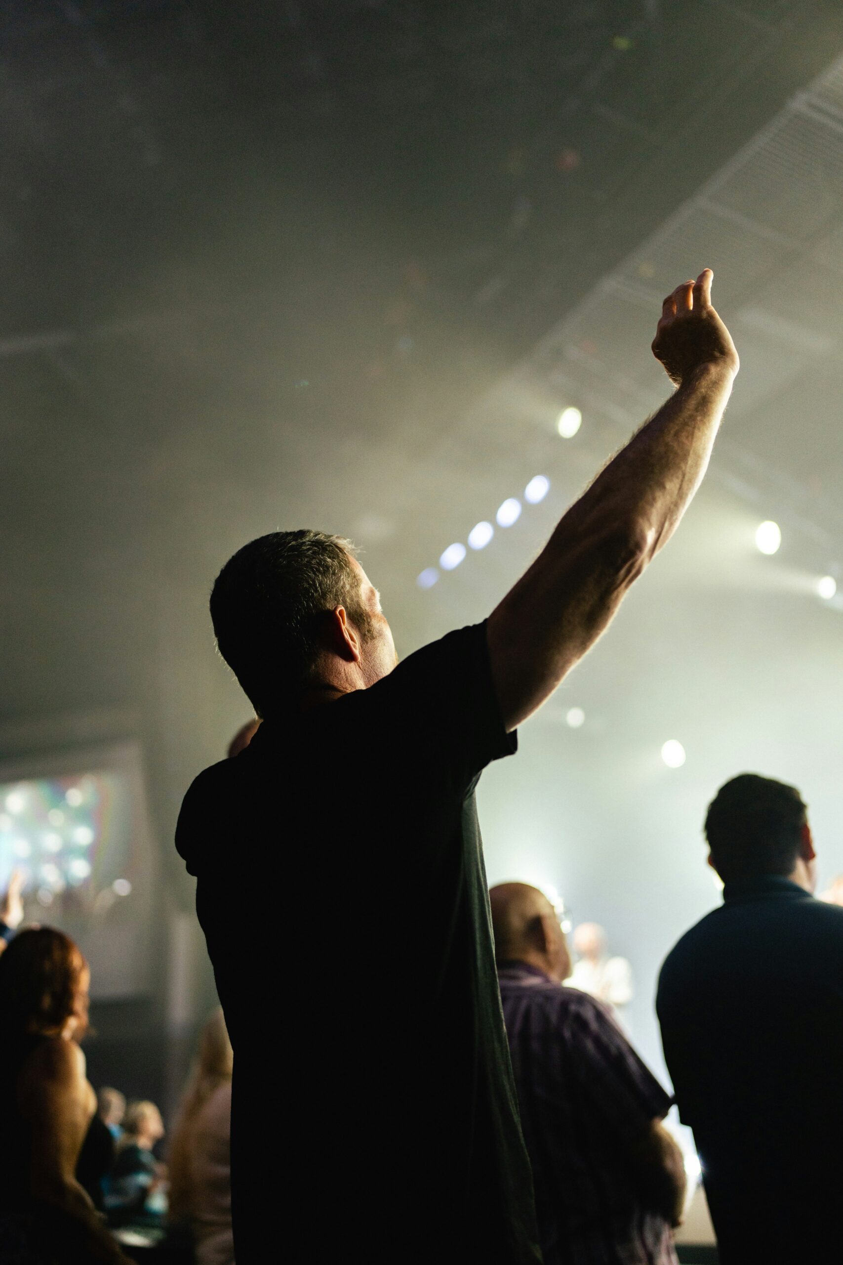 nathan-mullet-kNGWVUfQilw-unsplash man with hands raised in worship